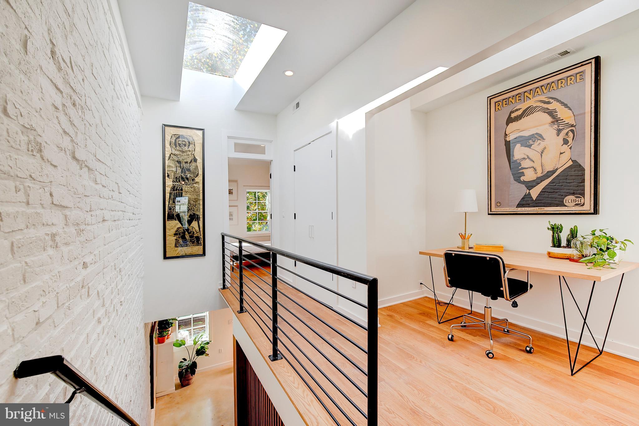443 Ridge Street Northwest Washington, DC 20001 - Photo 22 of 47 a bedroom with a bed and wooden floor
