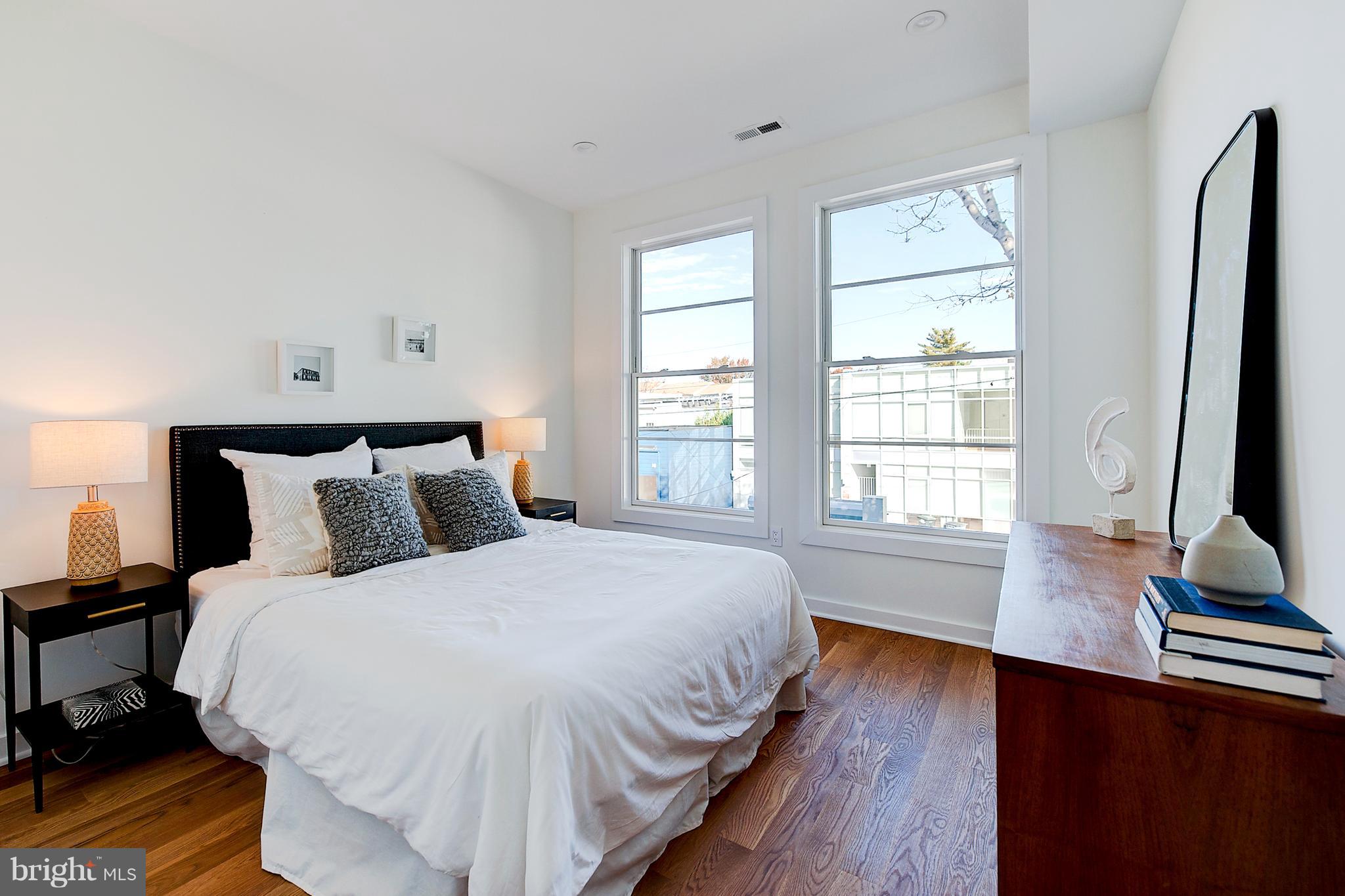 443 Ridge Street Northwest Washington, DC 20001 - Photo 25 of 47 a bed sitting in a bedroom next to a window