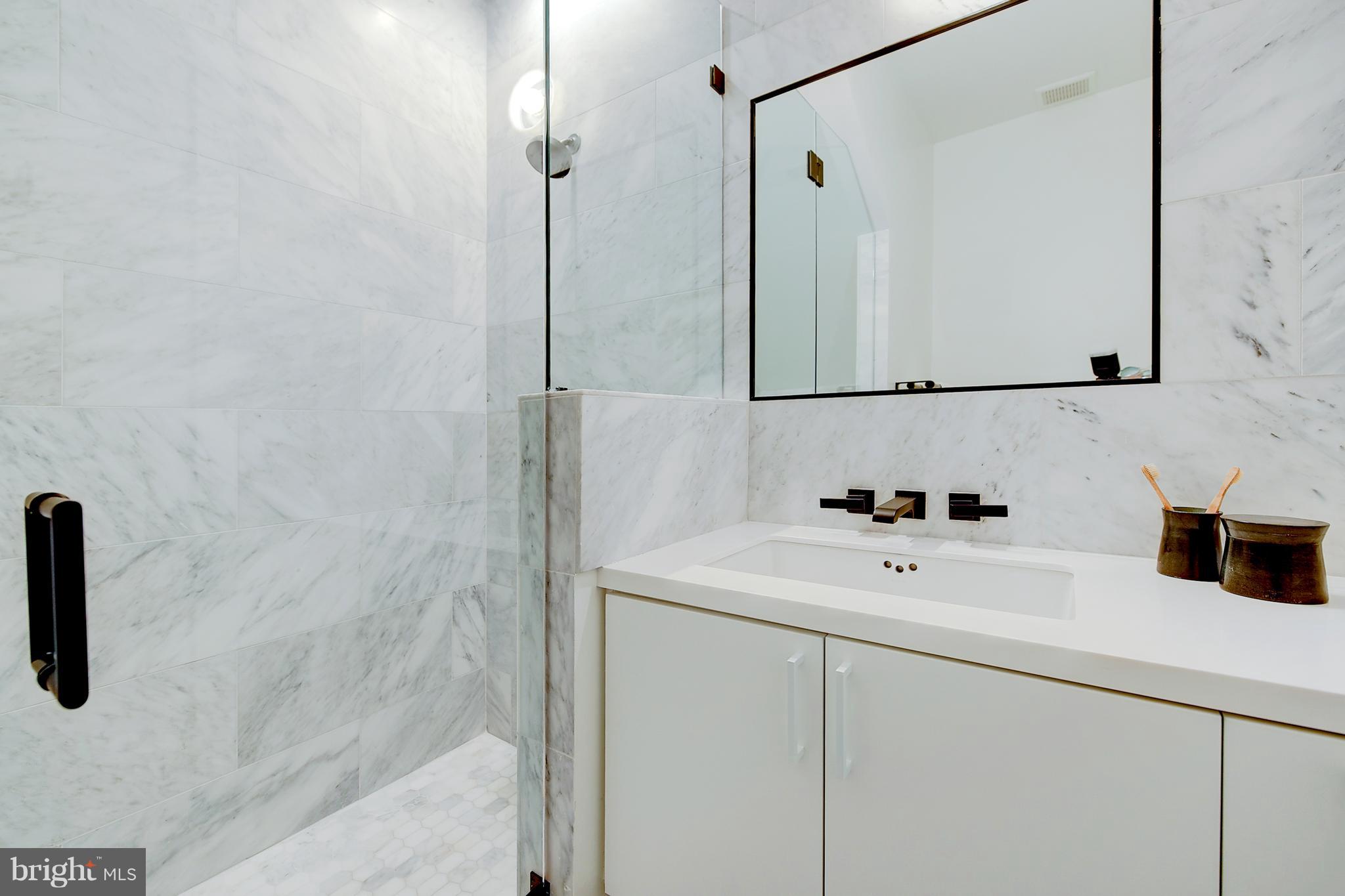 443 Ridge Street Northwest Washington, DC 20001 - Photo 26 of 47 a bathroom with a sink and a mirror