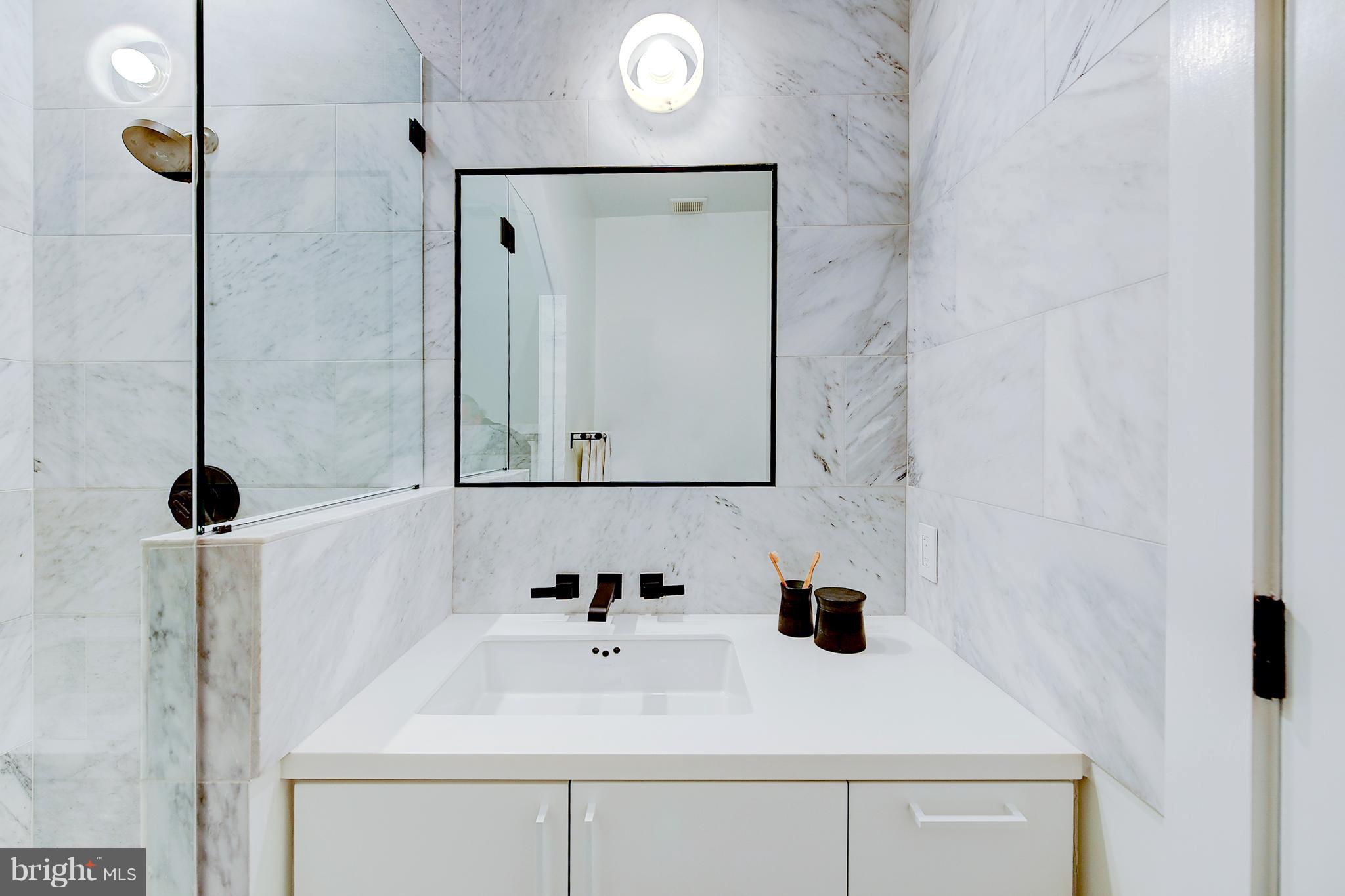 443 Ridge Street Northwest Washington, DC 20001 - Photo 27 of 47 a bathroom with a sink and a mirror