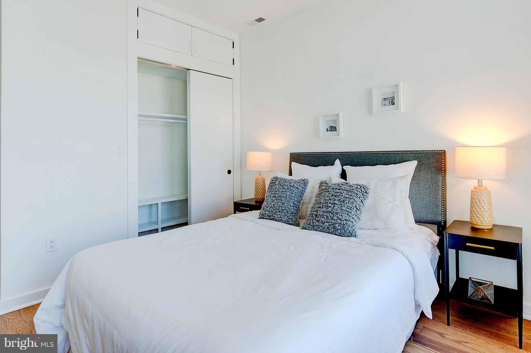 443 Ridge Street Northwest Washington, DC 20001 - Photo 28 of 47 a bed room with a bed and a lamp