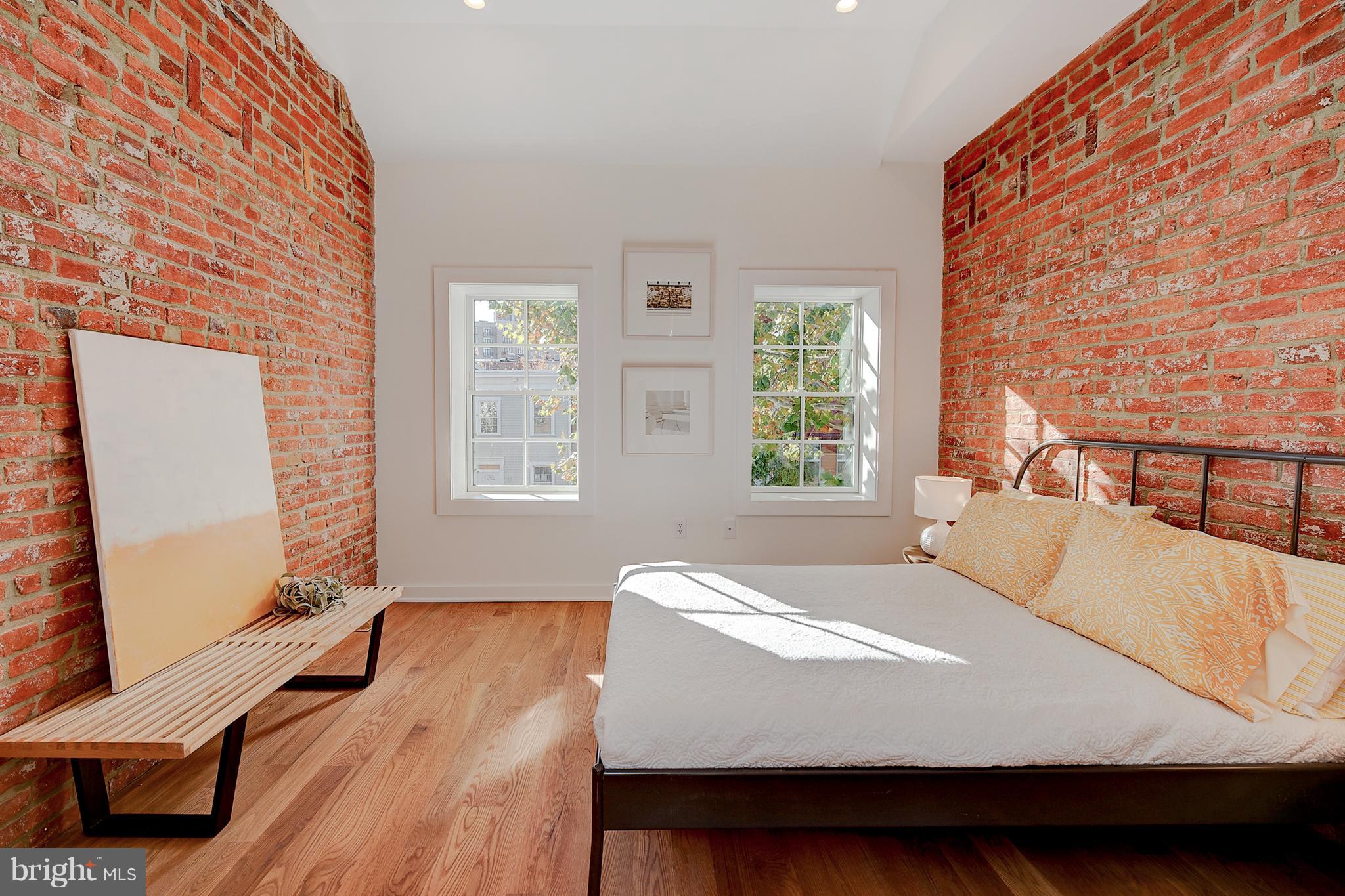 443 Ridge Street Northwest Washington, DC 20001 - Photo 31 of 47 a bed sitting in a bedroom next to a window