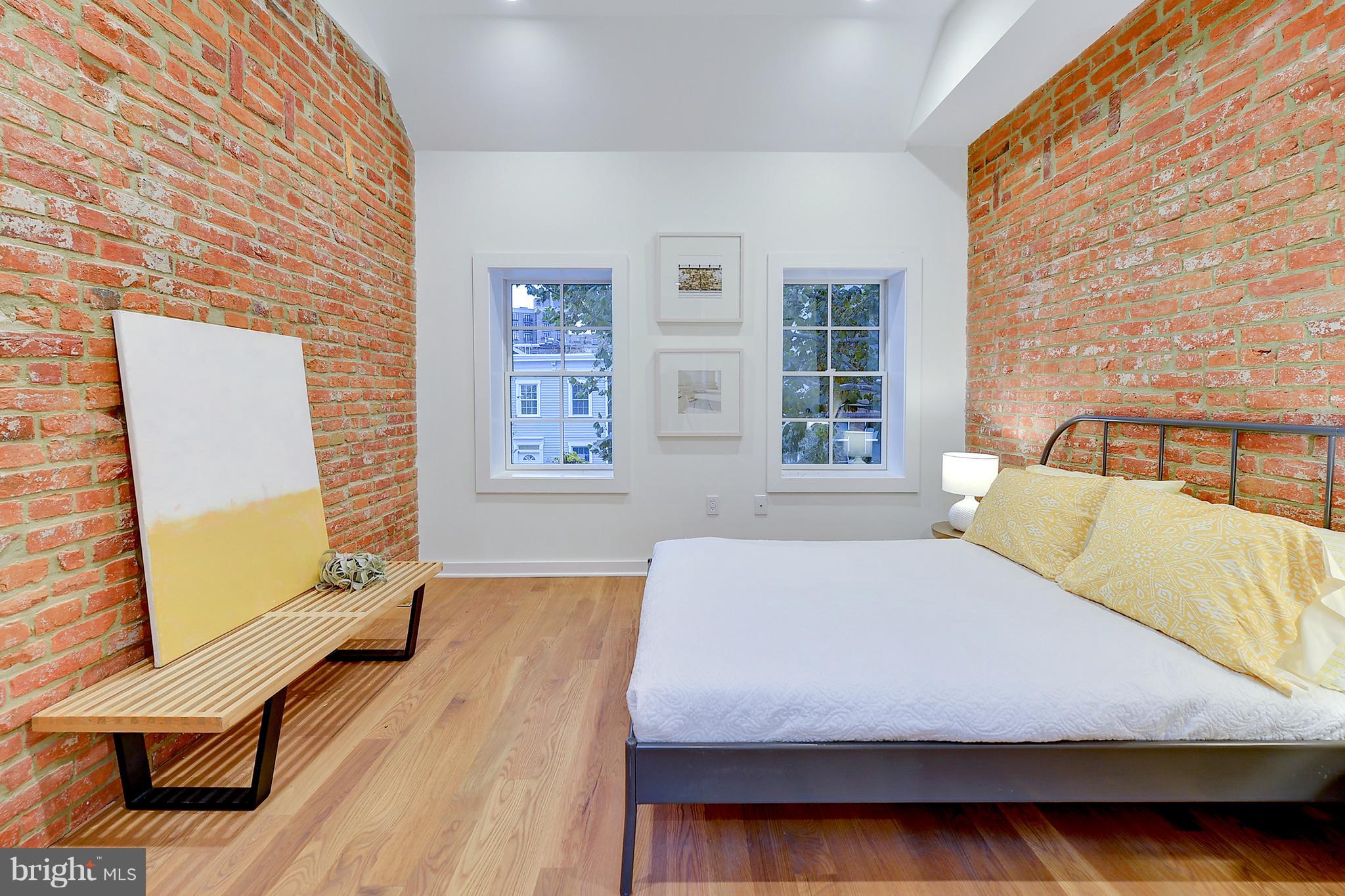 443 Ridge Street Northwest Washington, DC 20001 - Photo 34 of 47 a bedroom with a bed and wooden floor