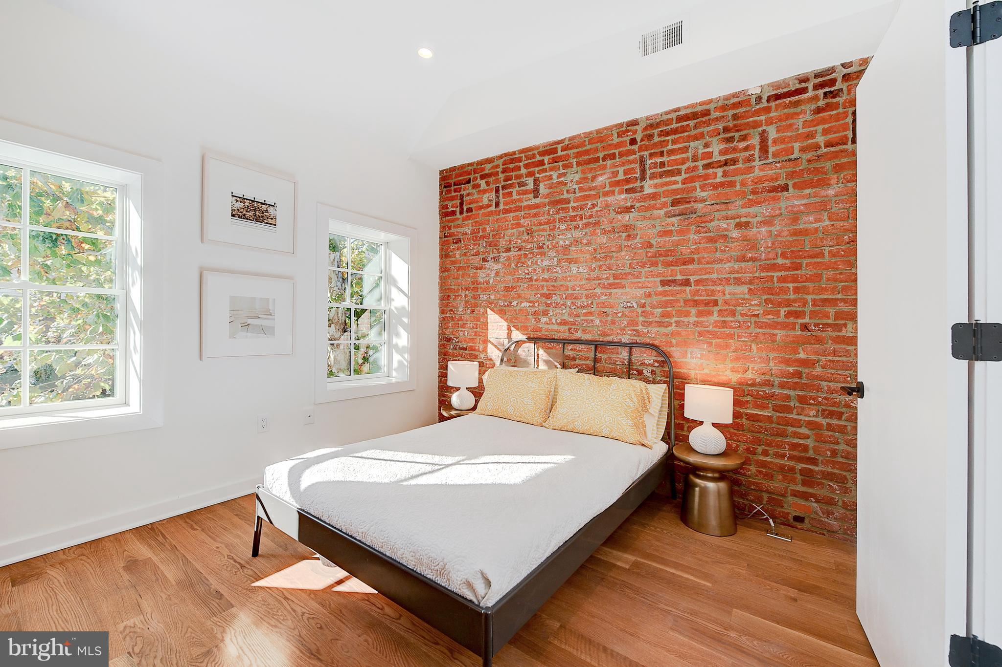 443 Ridge Street Northwest Washington, DC 20001 - Photo 35 of 47 a bed sitting in a bedroom next to a window