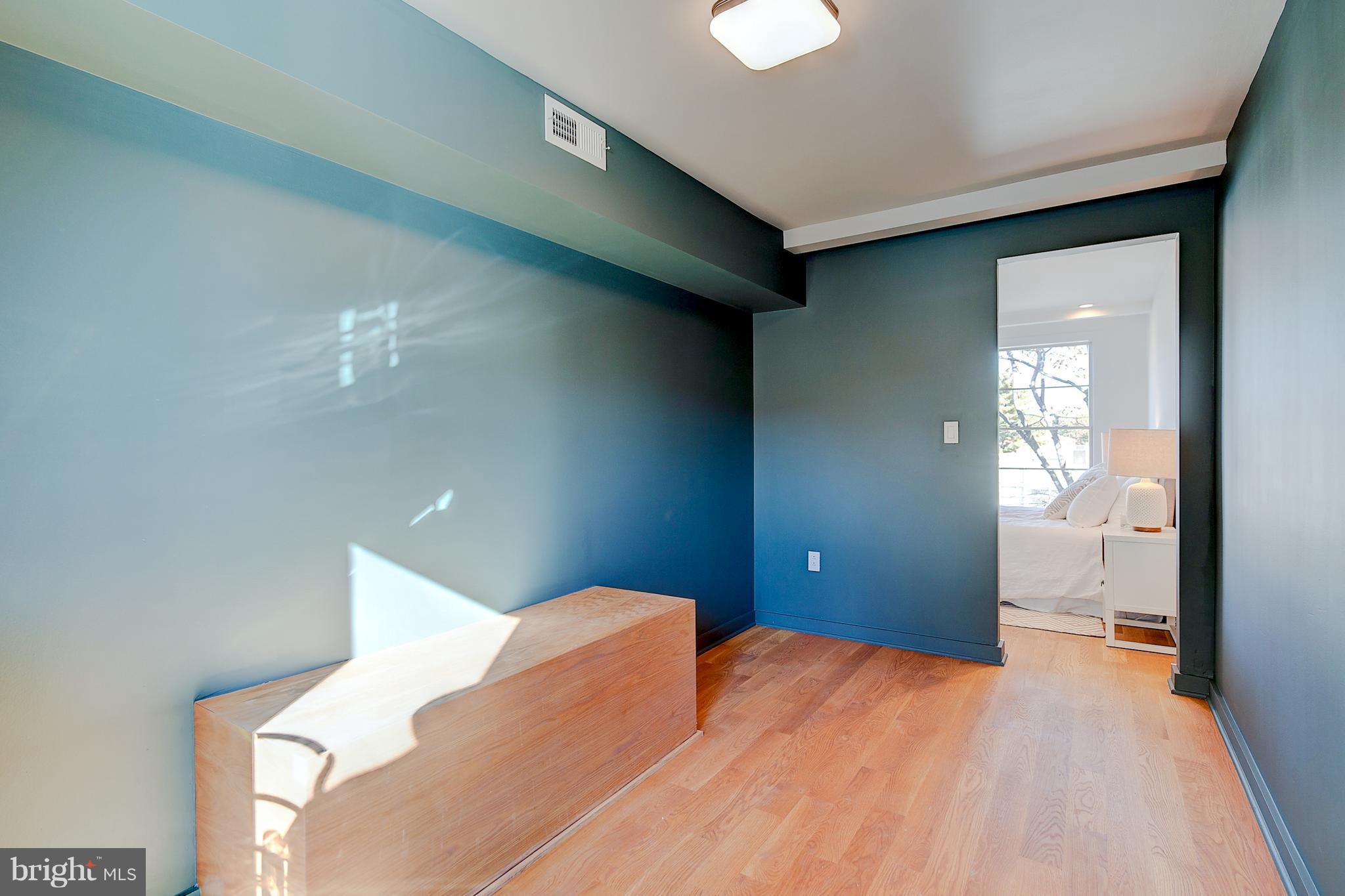 443 Ridge Street Northwest Washington, DC 20001 - Photo 38 of 47 a bedroom with a bed and a chandelier