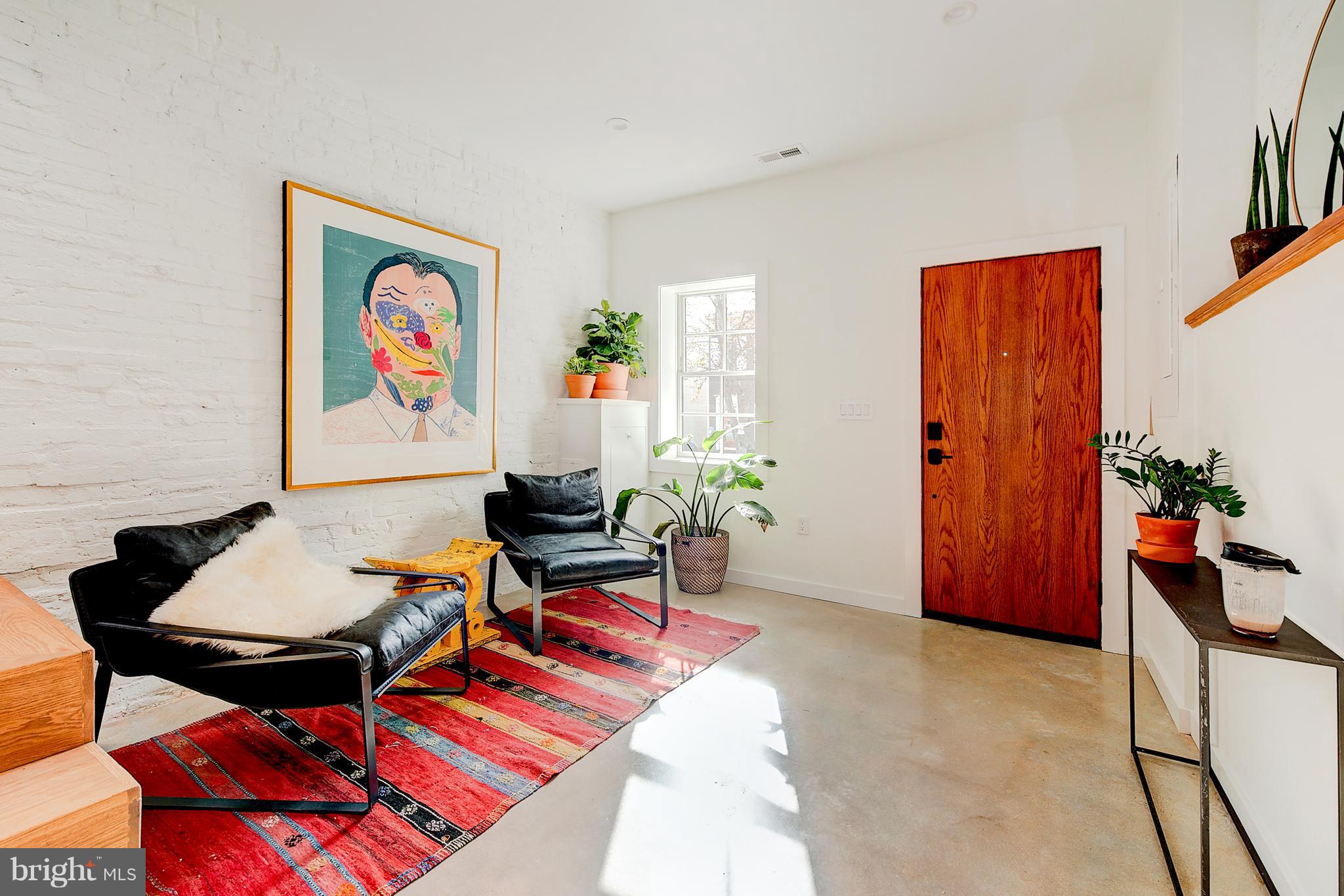 443 Ridge Street Northwest Washington, DC 20001 - Photo 4 of 47 a living room with furniture a rug and a wall painting