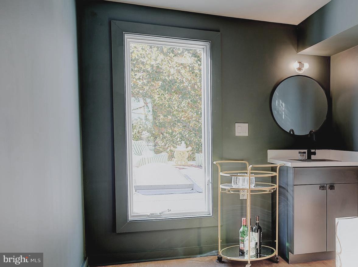 443 Ridge Street Northwest Washington, DC 20001 - Photo 40 of 47 a bathroom with a sink mirror and window