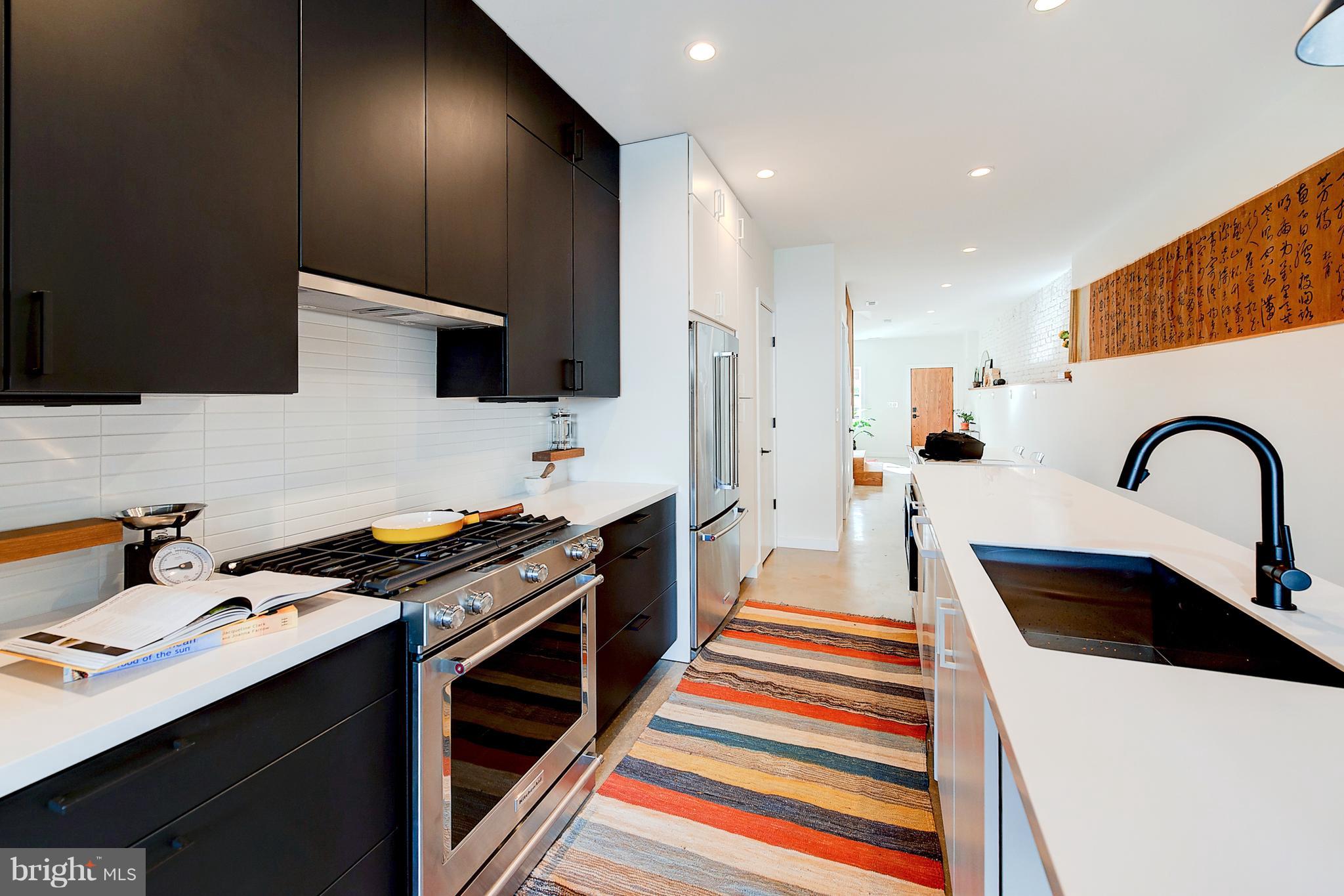 443 Ridge Street Northwest Washington, DC 20001 - Photo 5 of 47 a kitchen with a sink a stove and a microwave
