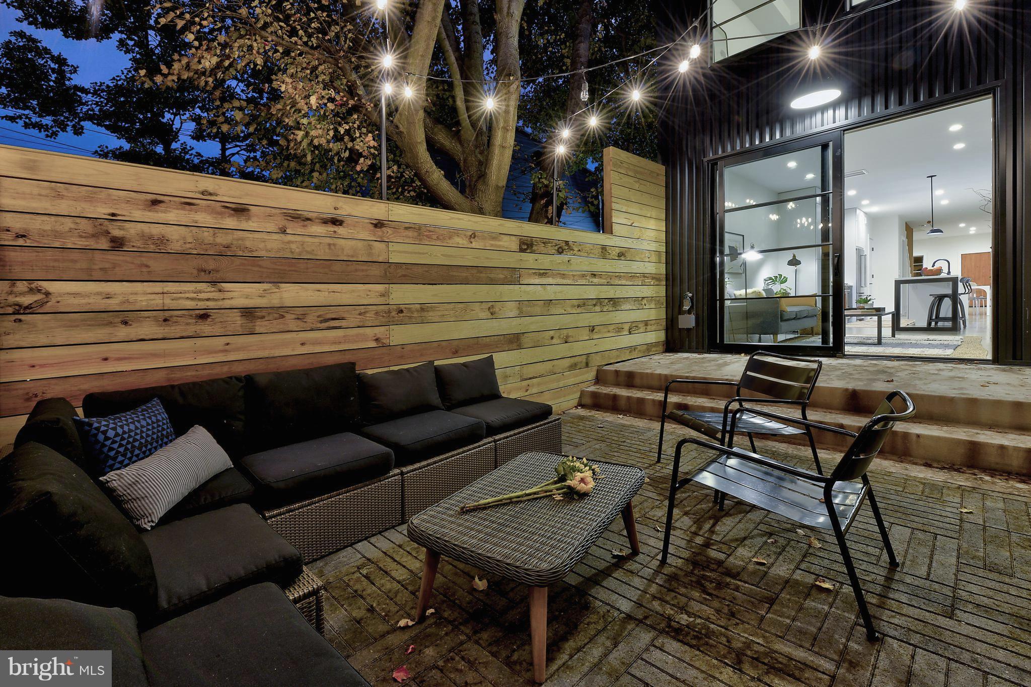 443 Ridge Street Northwest Washington, DC 20001 - Photo 6 of 47 a roof deck with a couch and chairs