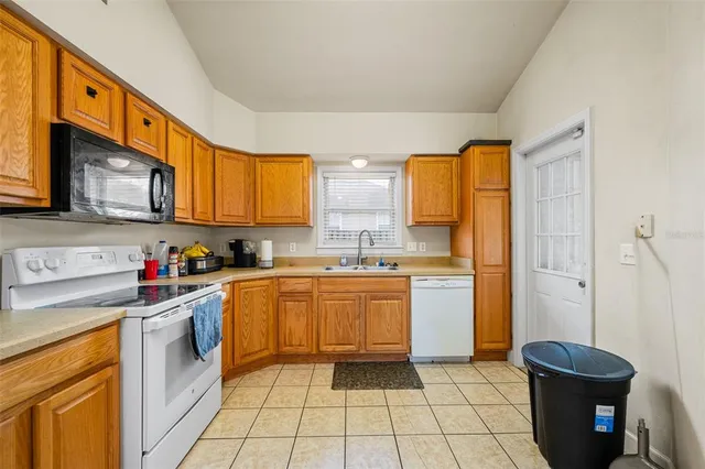 a kitchen with stainless steel appliances granite countertop a sink and cabinets