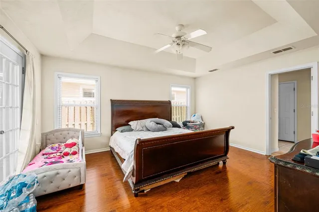 a bedroom with a bed and a chandelier