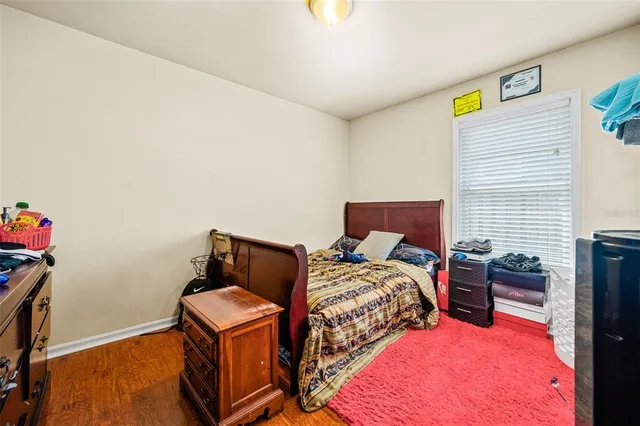 a bed room with a bed and a computer on a desk
