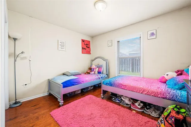 a bedroom with bed and a window