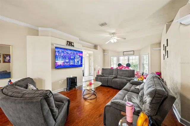 a living room with furniture and a flat screen tv