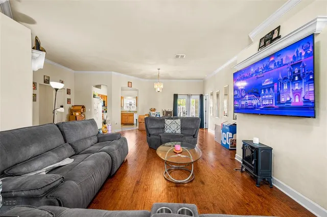 a living room with furniture and a dining table