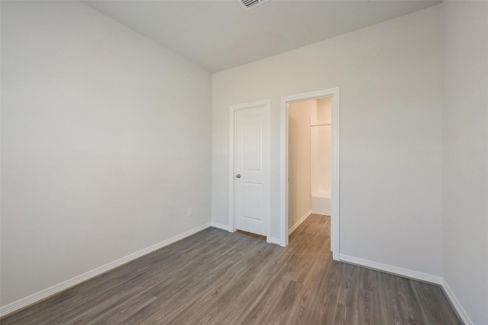 6835 New York Street Houston, TX 77021 - Photo 7 of 12 a view of an empty room with wooden floor