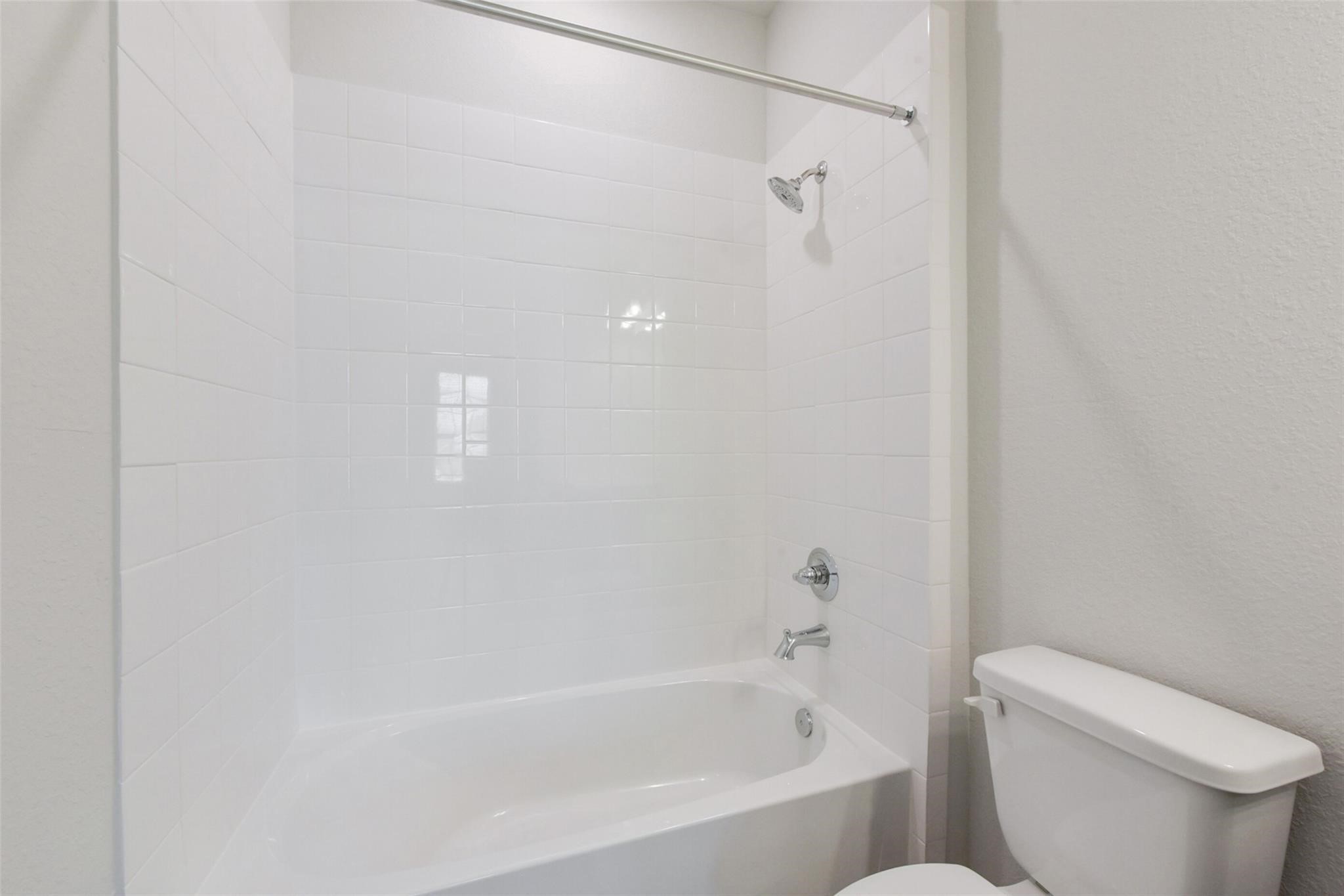 6835 New York Street Houston, TX 77021 - Photo 9 of 12 a white bath tub sitting next to a toilet