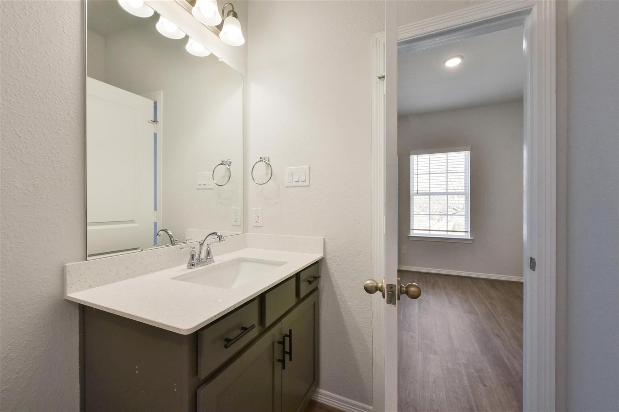 6835 New York Street Houston, TX 77021 - Photo 10 of 12 a bathroom with a sink a mirror and a vanity
