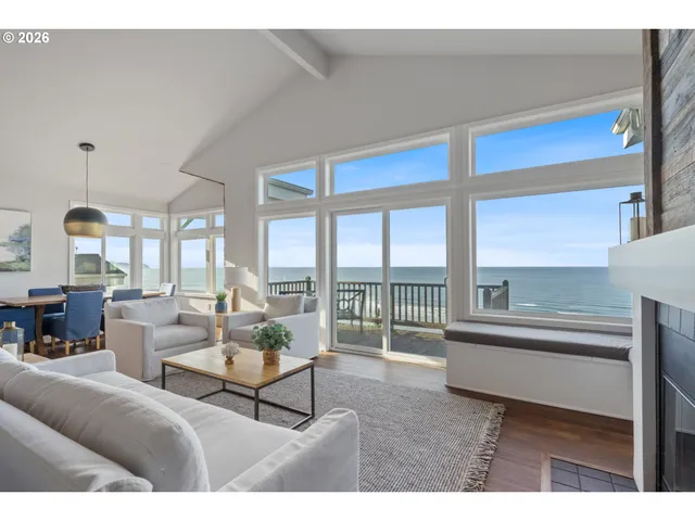 a living room with furniture and a floor to ceiling window