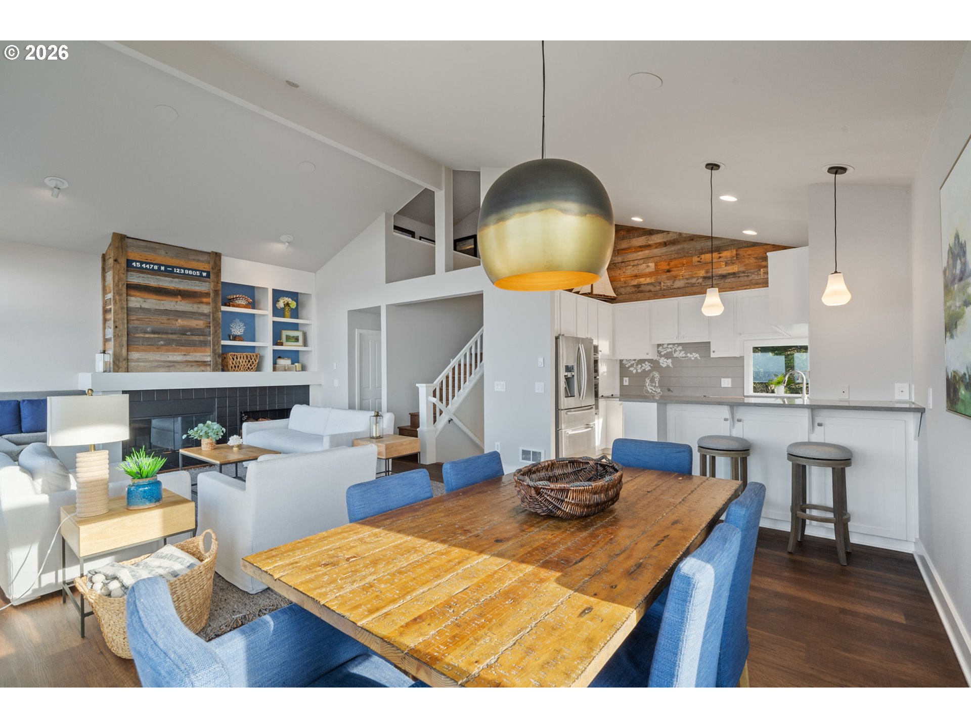 355 Promontory Lane Oceanside, OR 97141 - Photo 9 of 48 a kitchen with stainless steel appliances granite countertop a stove a sink a dining table and chairs with wooden floor