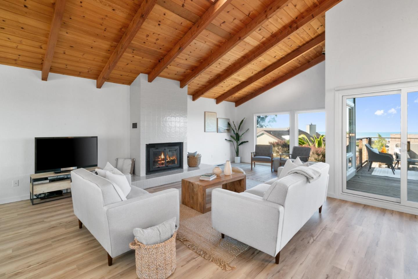 1102 Vía Tornasol Aptos, CA 95003 - Photo 7 of 67 a living room with furniture a fireplace and a flat screen tv