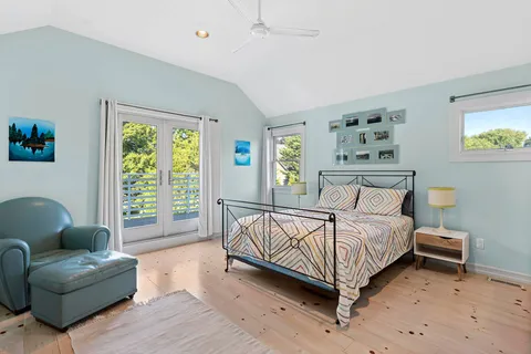 a bedroom with a bed couch and a window