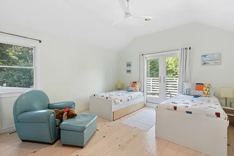 a bedroom with furniture and a large window