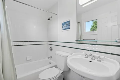 a bathroom with a sink a toilet and bathtub