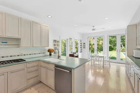 a kitchen with a white cabinets stove and sink