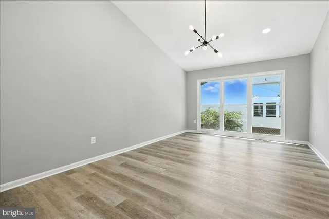 a view of an empty room with a ceiling fan