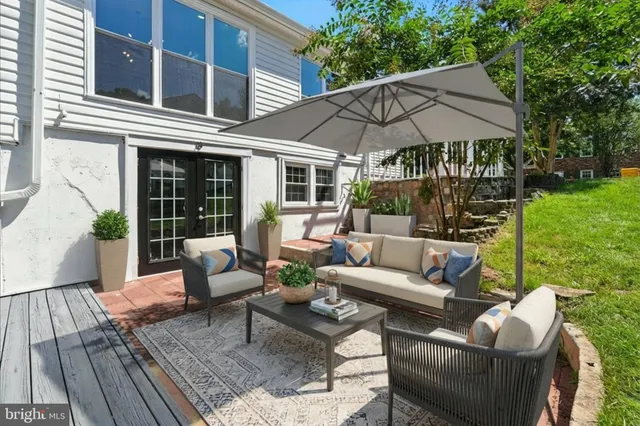 a large kitchen with stainless steel appliances a large counter top a stove and a wooden floors