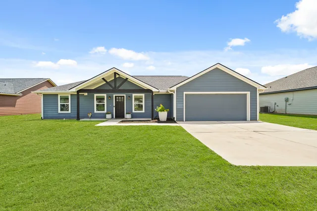 a front view of a house with a garden