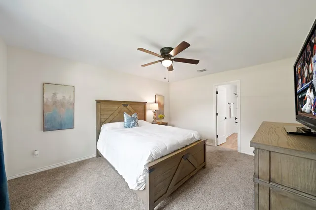 a bedroom with a bed and a table