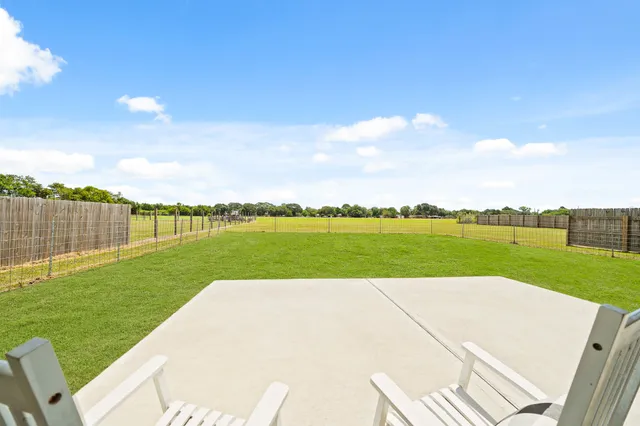 an empty room with a window and a ceiling fan