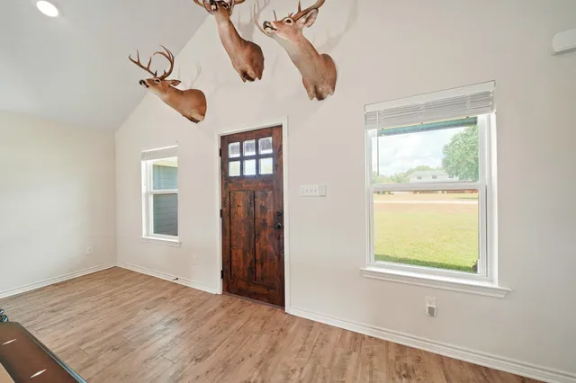 a view of an entryway with wooden floor and a window