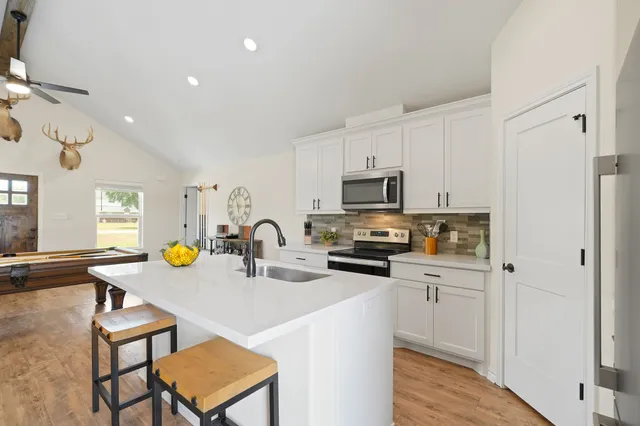 a kitchen with sink cabinets and appliances