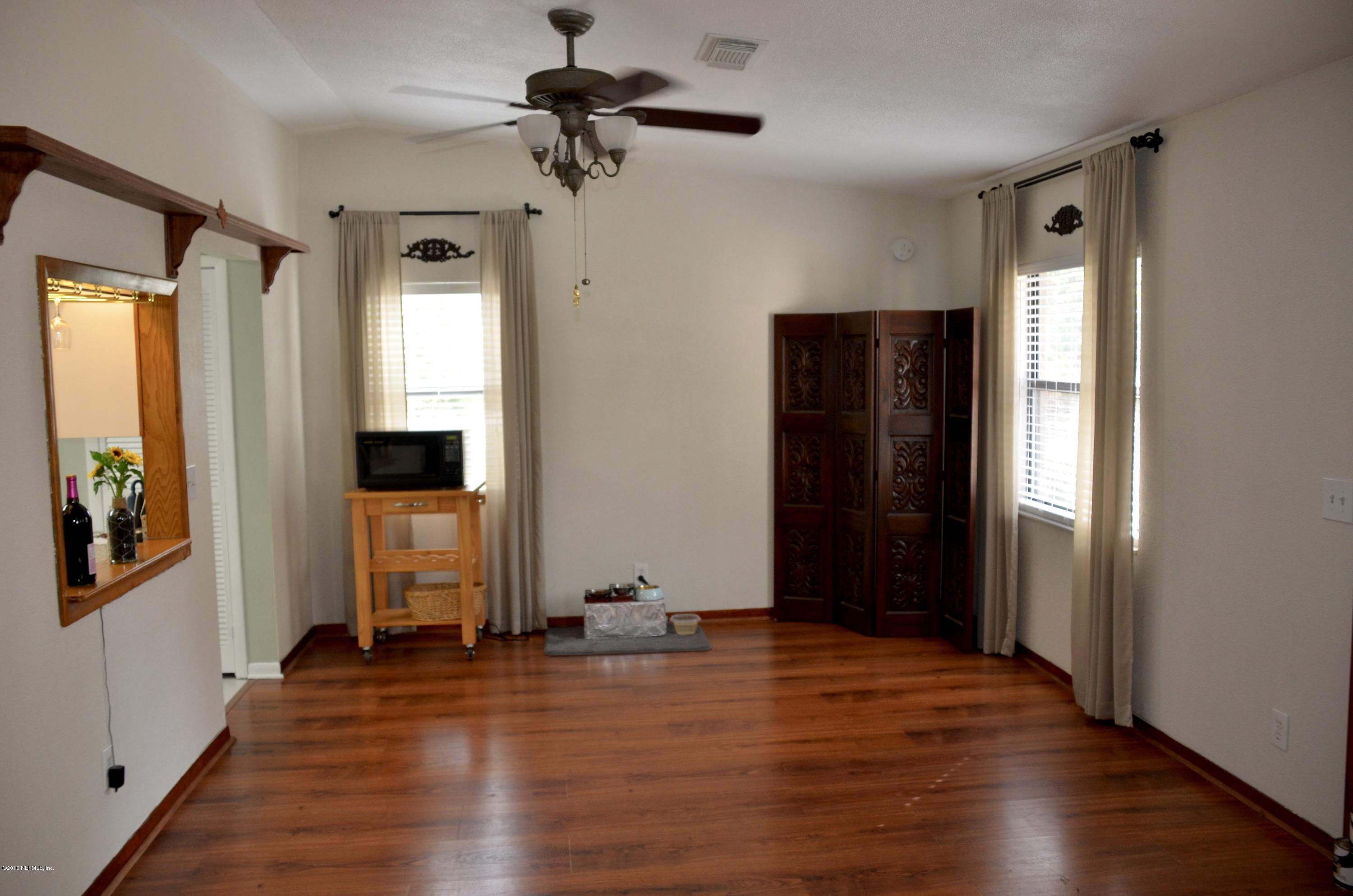 540516 Lem Turner Road Callahan, FL 32011 - Photo 12 of 26 wooden floor in an empty room with a window