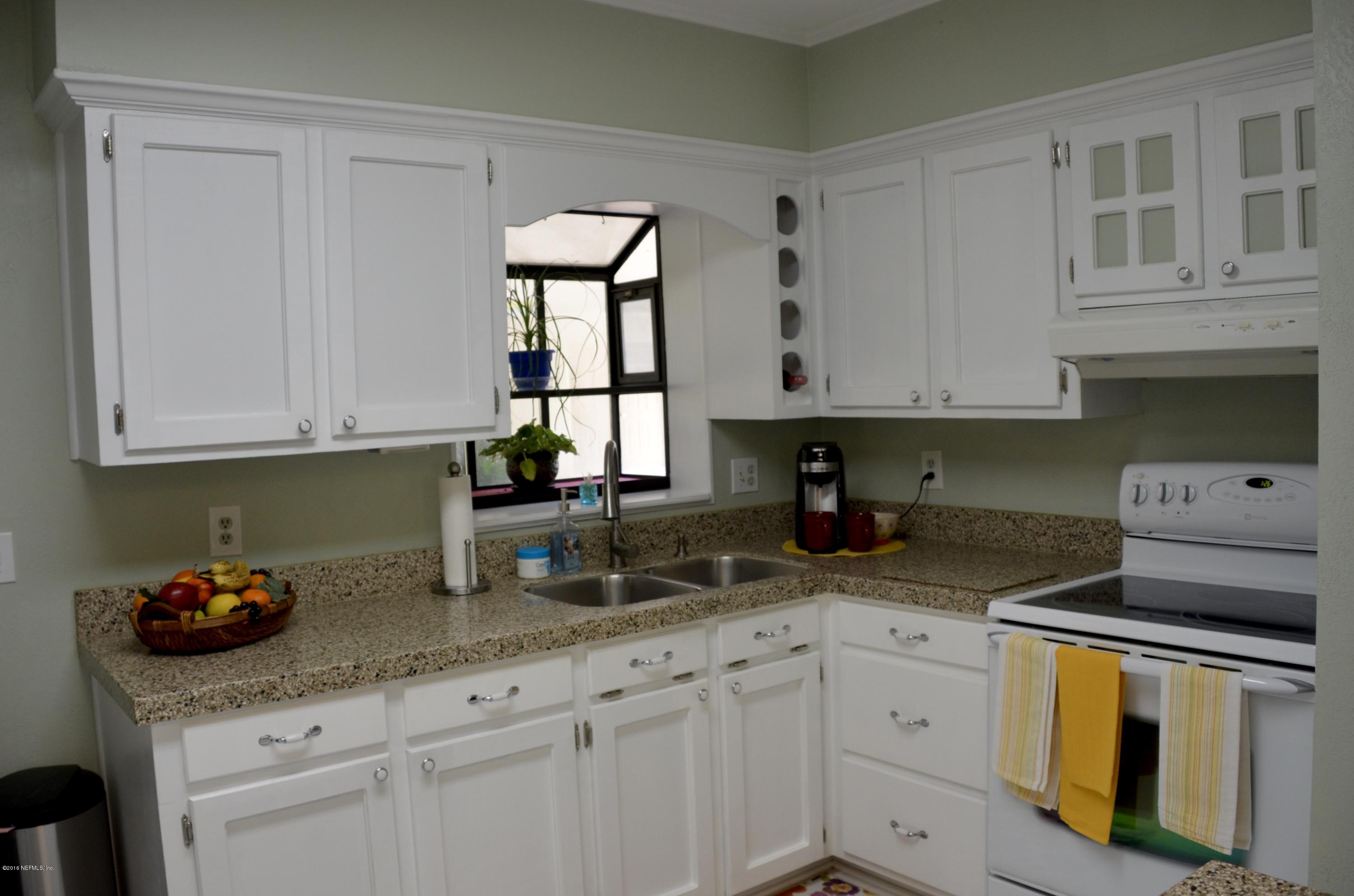 540516 Lem Turner Road Callahan, FL 32011 - Photo 13 of 26 a kitchen with granite countertop white cabinets and white appliances