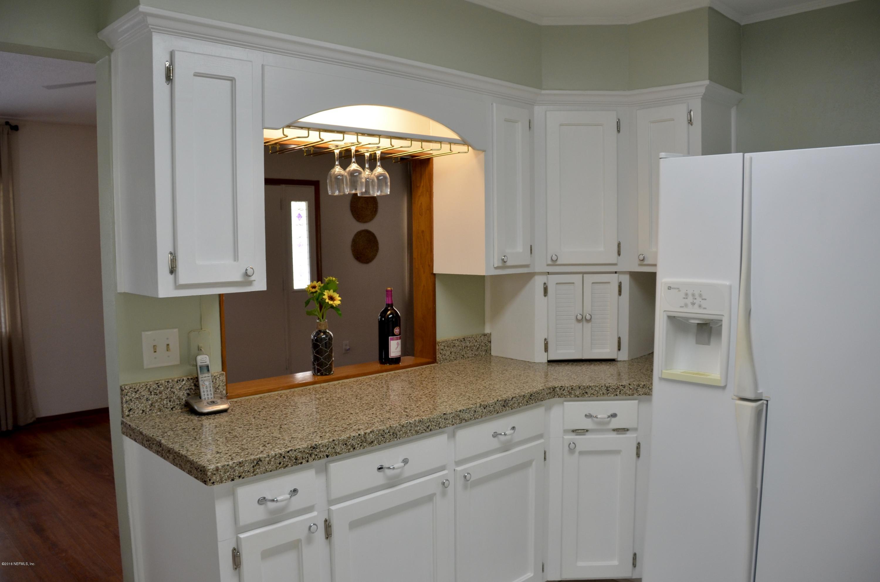 540516 Lem Turner Road Callahan, FL 32011 - Photo 14 of 26 a kitchen with stainless steel appliances granite countertop a sink and cabinets