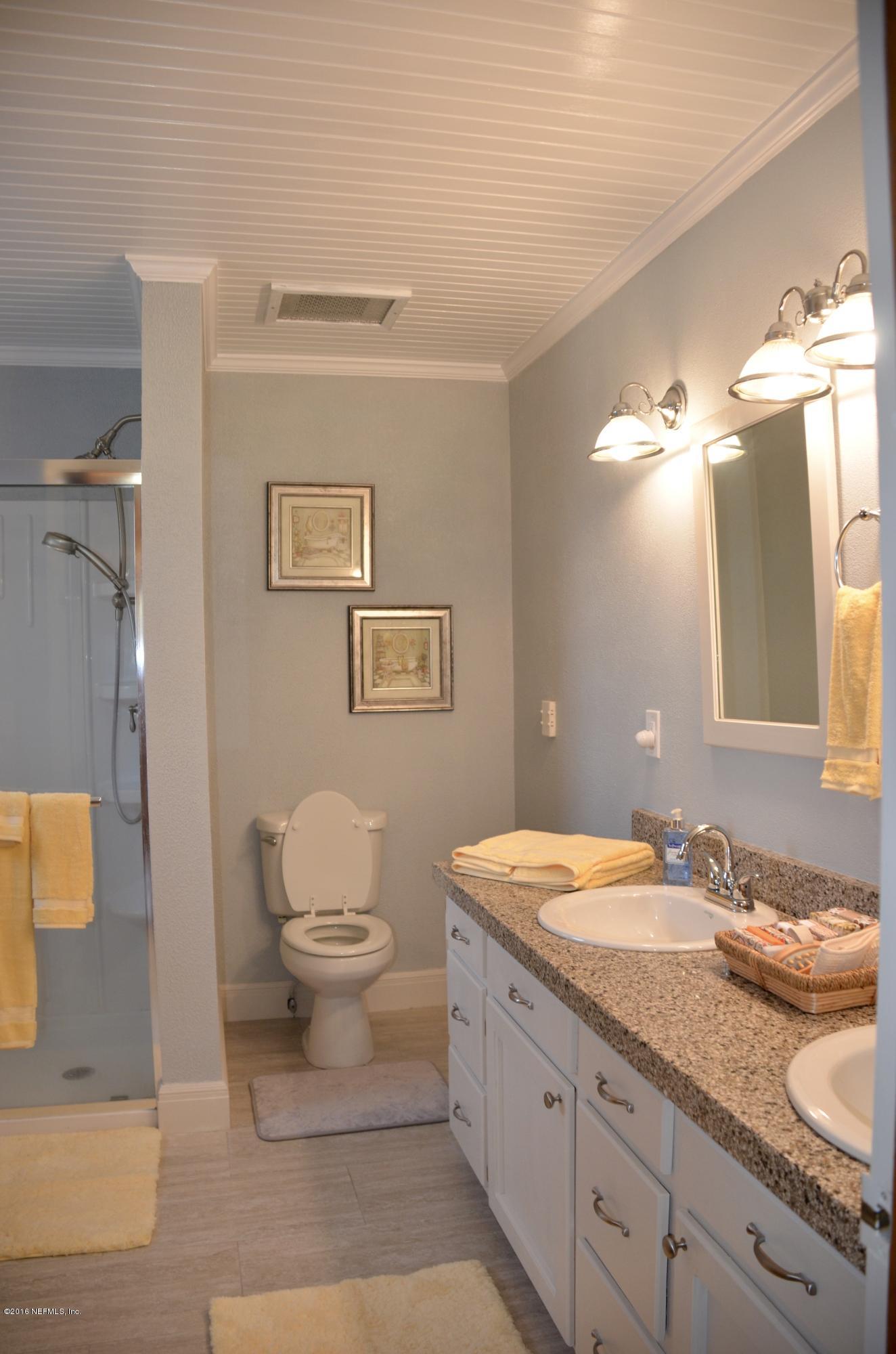540516 Lem Turner Road Callahan, FL 32011 - Photo 19 of 26 a bathroom with a granite countertop sink mirror vanity and toilet