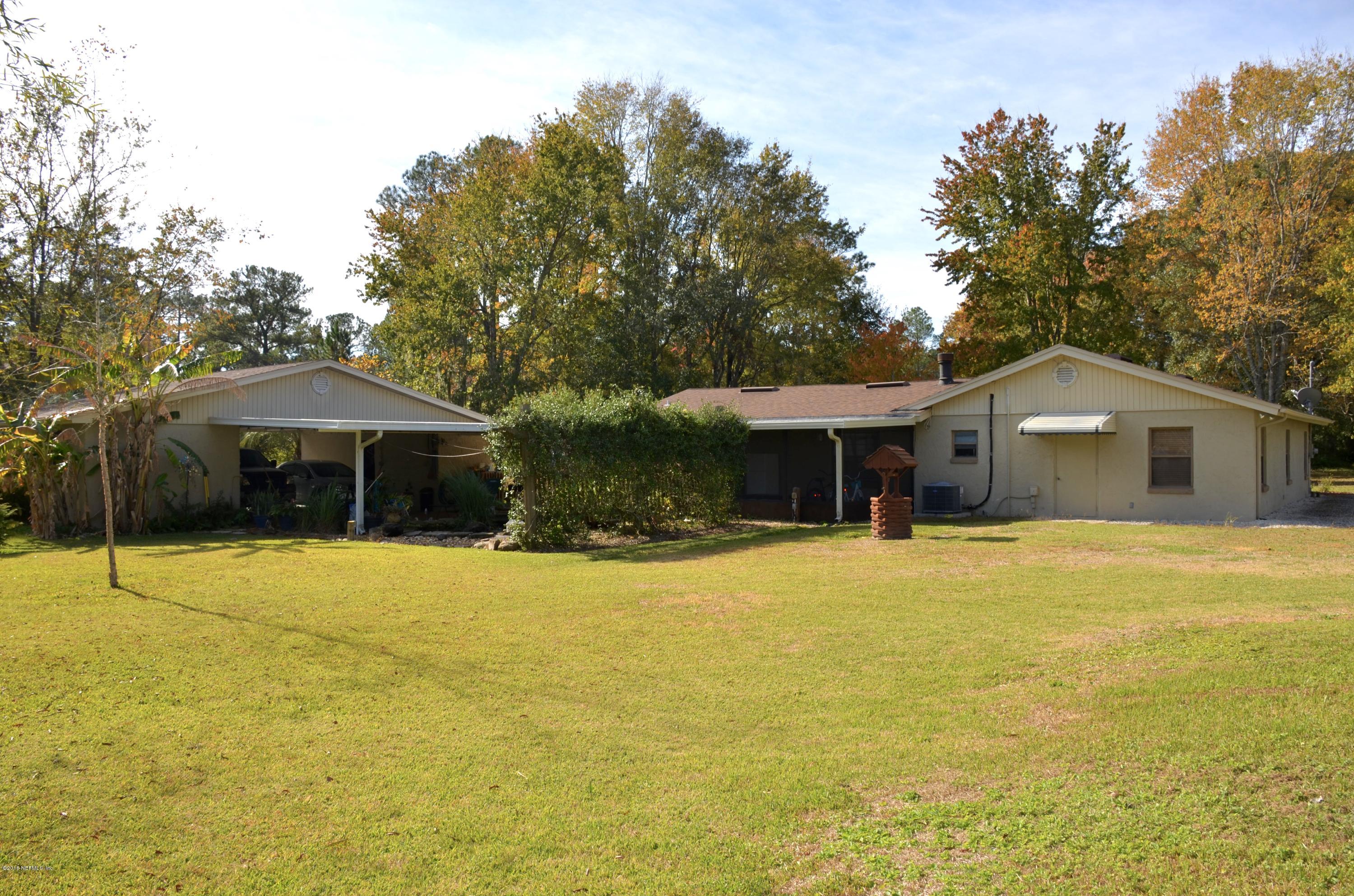 540516 Lem Turner Road Callahan, FL 32011 - Photo 26 of 26 a front view of a house with yard and trees