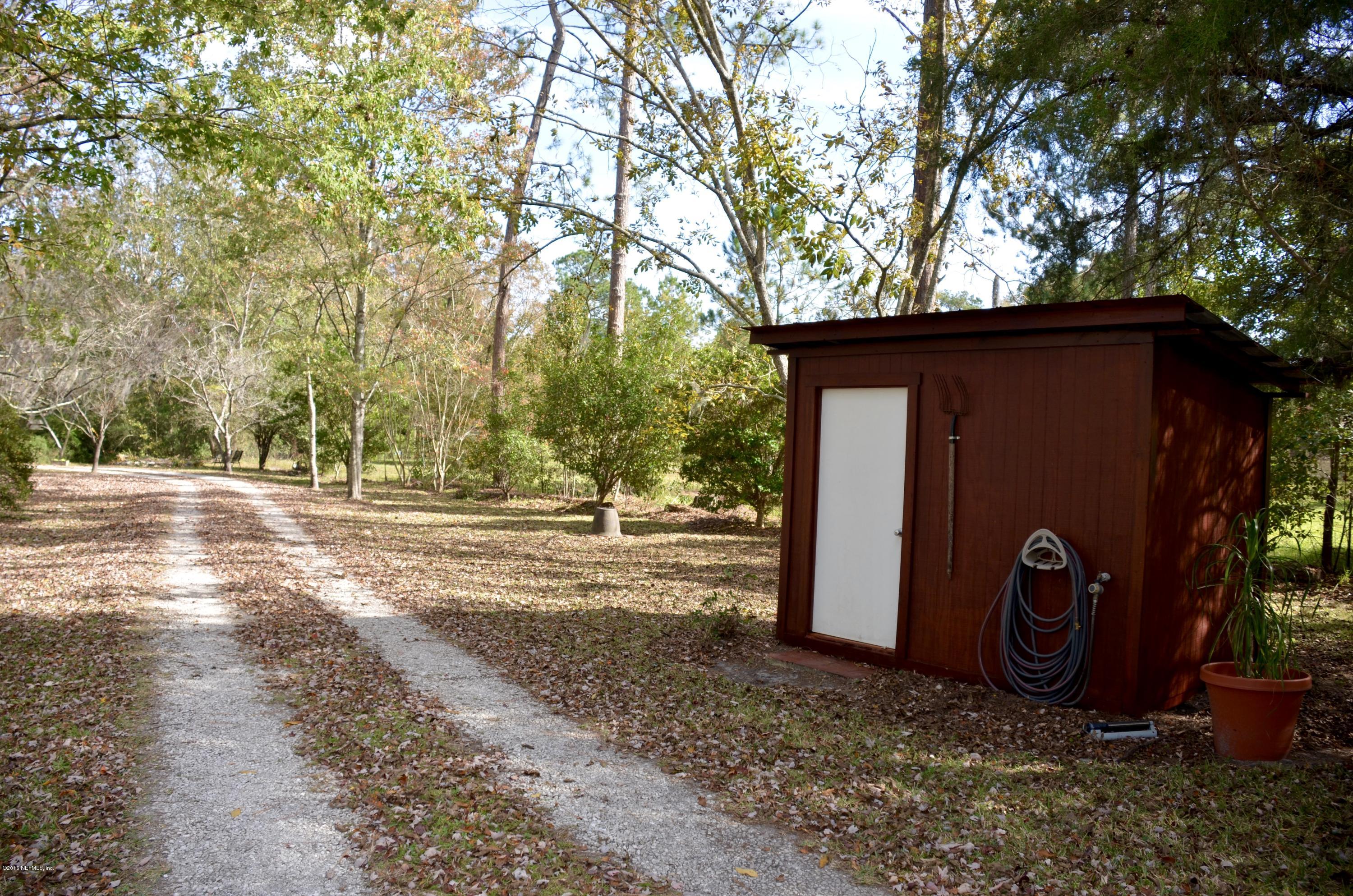 540516 Lem Turner Road Callahan, FL 32011 - Photo 4 of 26 a view of a barn in the middle of a yard