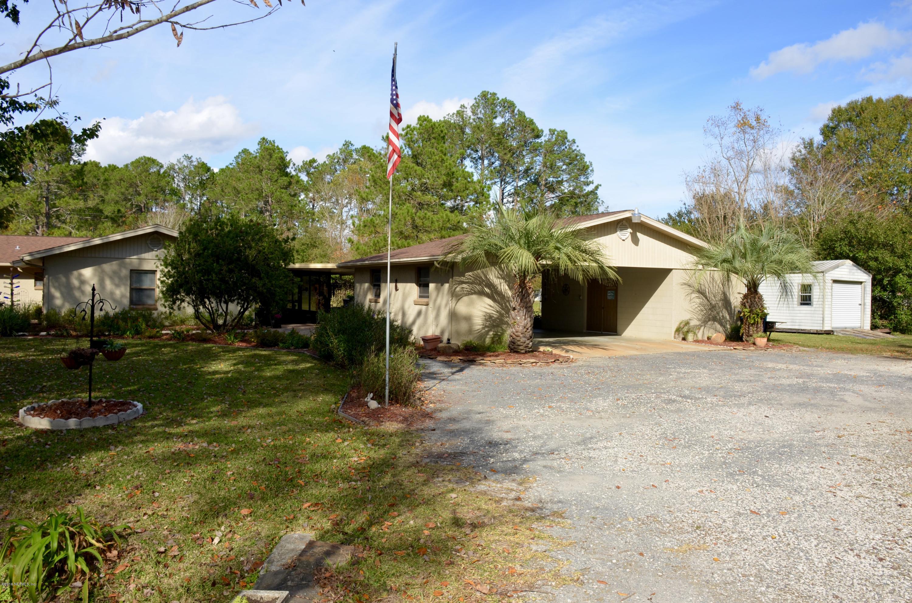 540516 Lem Turner Road Callahan, FL 32011 - Photo 5 of 26 a front view of a house with a yard and garage