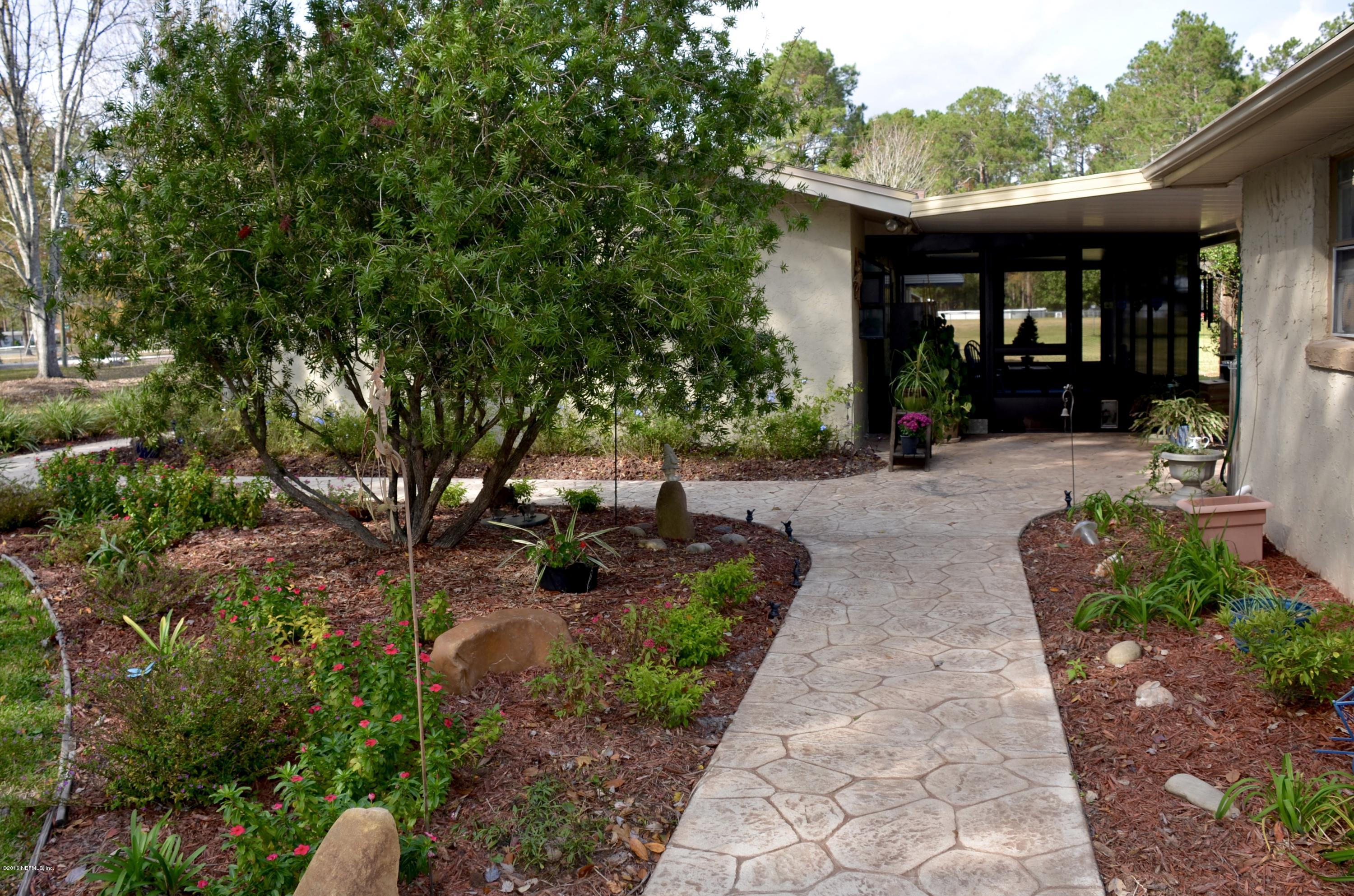540516 Lem Turner Road Callahan, FL 32011 - Photo 7 of 26 a view of a patio with table and chairs and potted plants