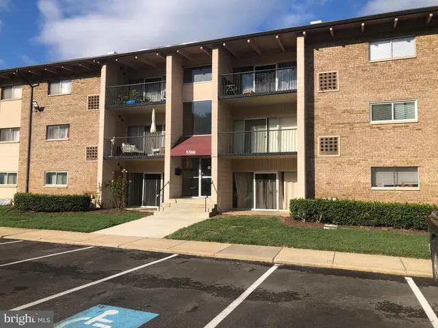 a view of a brick building next to a yard
