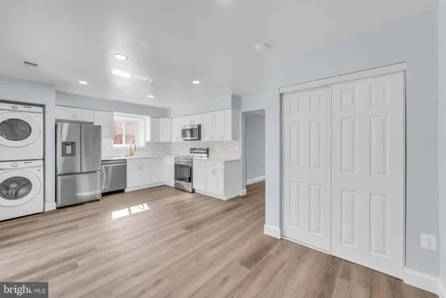 a view of a kitchen with refrigerator and microwave