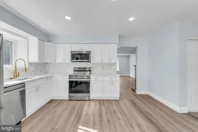 a kitchen with a sink cabinets and stainless steel appliances