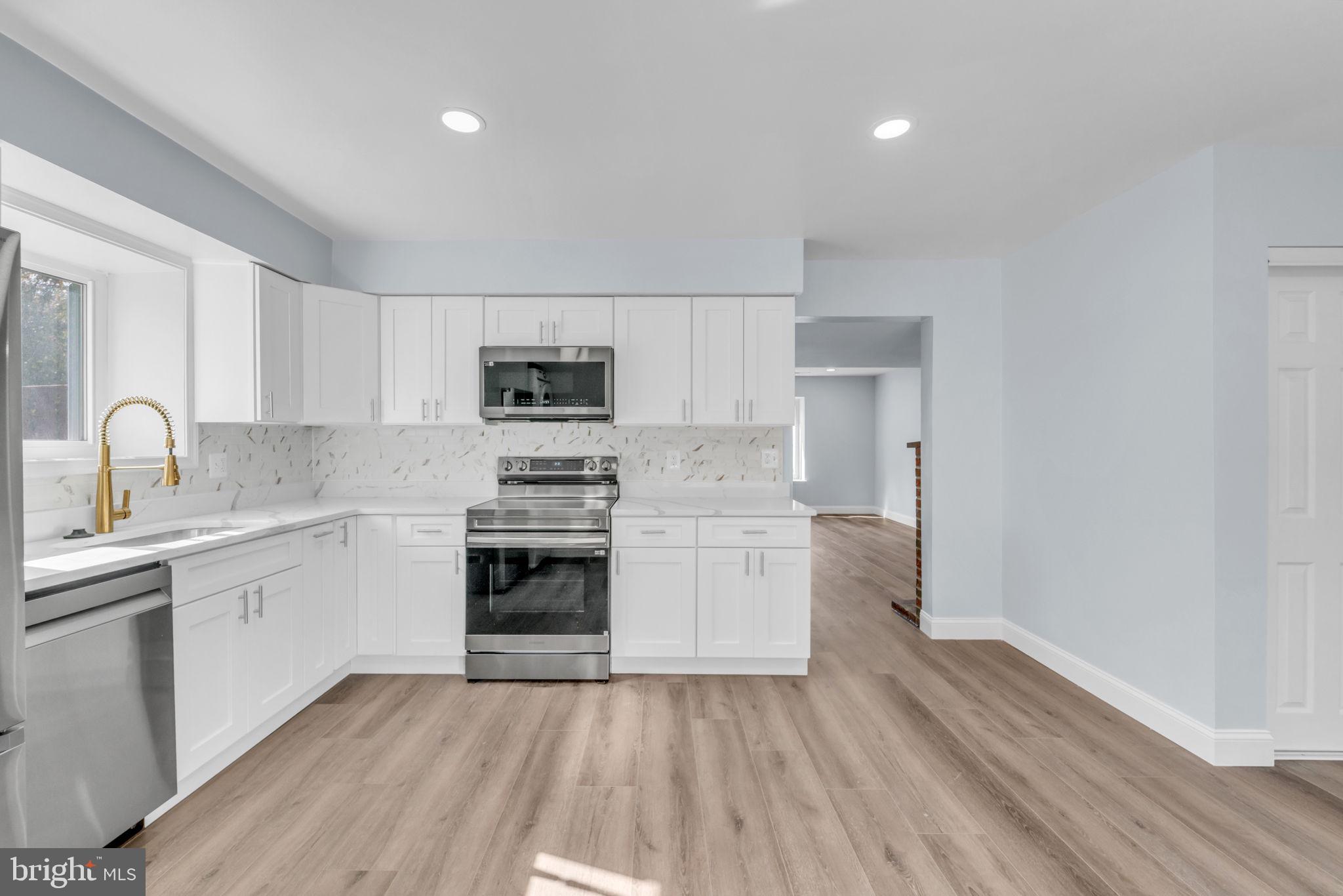13314 Apgar Place Herndon, VA 20170 - Photo 15 of 39 a kitchen with a sink cabinets and stainless steel appliances