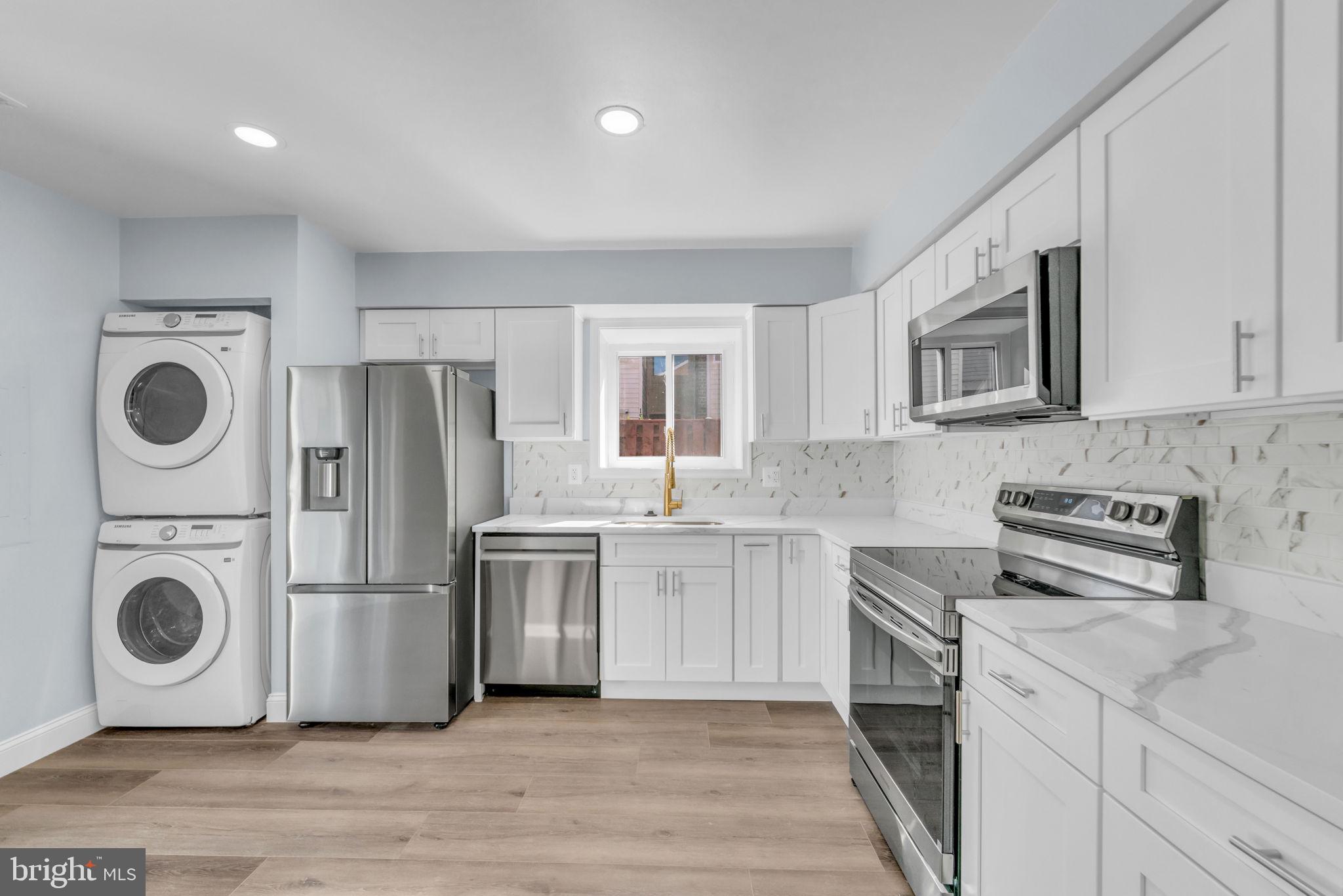 13314 Apgar Place Herndon, VA 20170 - Photo 16 of 39 a kitchen with a stove a sink and a refrigerator