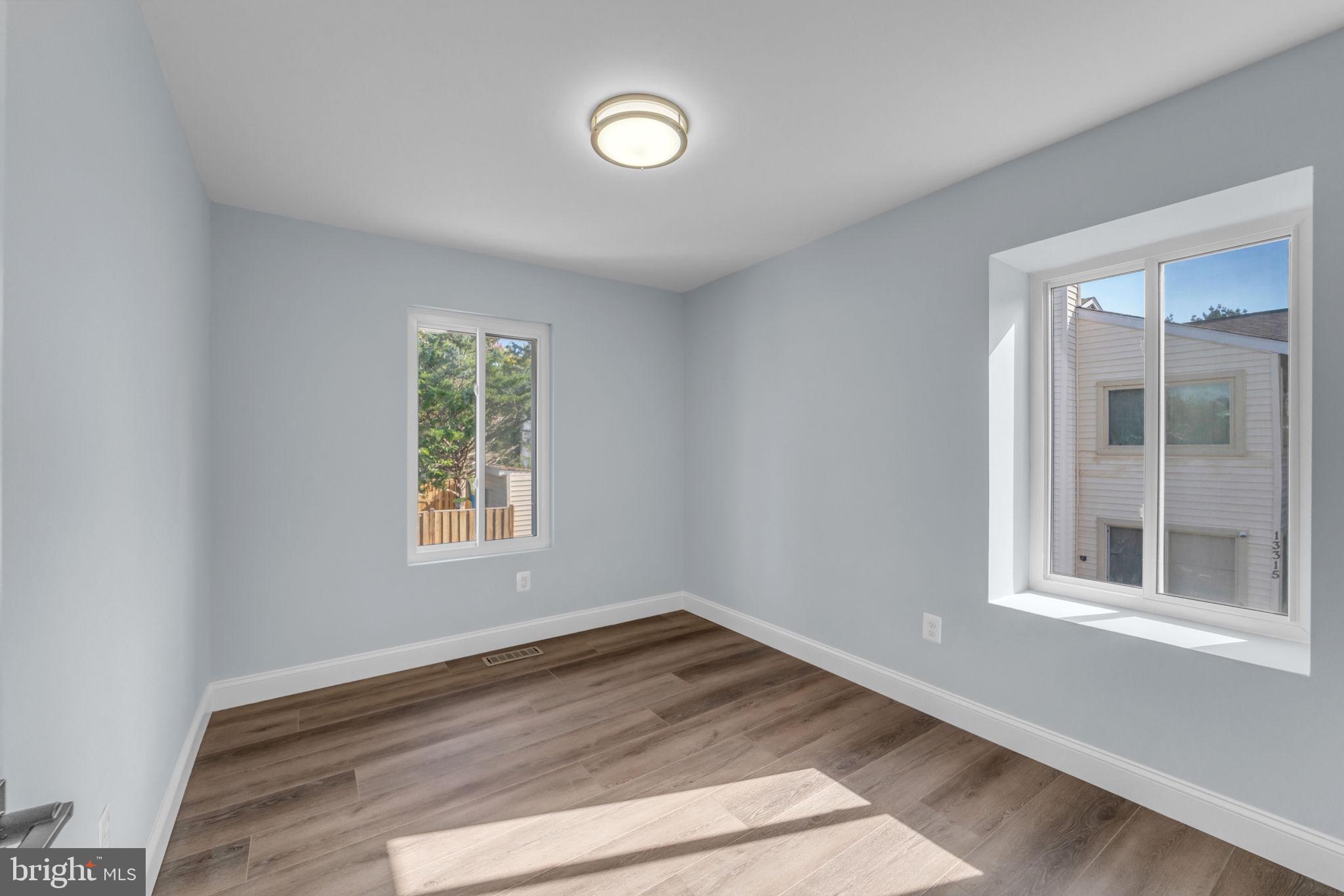 13314 Apgar Place Herndon, VA 20170 - Photo 20 of 39 a view of an empty room with wooden floor and a window